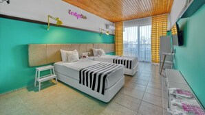 A hotel room with two beds, a small table, a bench, and a TV. - Anjeliq Downtown Hotel (Alanya)