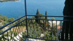 A balcony with a view of a coastal area, including a body of water and distant land. - Apartment in Trogir with Seaview, Balcony, Air condition, WIFI (5055-2) (Trogir)