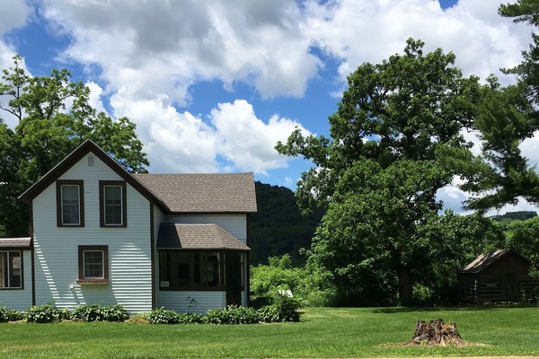 The Farmhouse. You'll enter through the porch on the left side of the house.