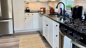 A modern kitchen with white cabinets, stainless steel appliances, and a black stove. - 2 Bedroom/Pet Friendly/short walk to Village (Skaneateles)