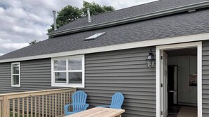 A house with a deck, two blue Adirondack chairs, and a wooden picnic table. - 2 Bedroom/Pet Friendly/short walk to Village (Skaneateles)