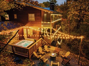 Relax on the two-story deck with Adirondack chairs and a fire pit, or unwind in the hot tub.