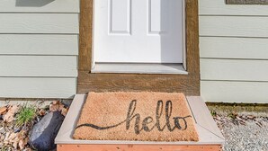 A white front door with a wreath, a mailbox, and a 'hello' mat. - Fried Egg Flat (Moscow)