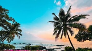 A coastal view with palm trees and a sunset. - Luxury Oceanfront Private Estate, large family gatherings (Kailua-Kona)