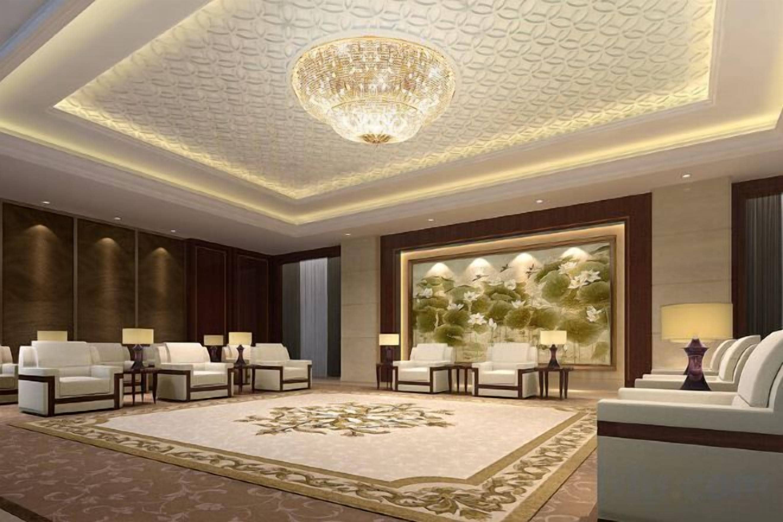 A spacious lobby with a large chandelier, plush seating, and a decorative wall.