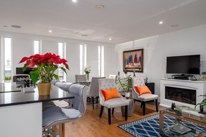 Relax in this stylish living room with a central island, comfortable seating, and a flat-screen TV.