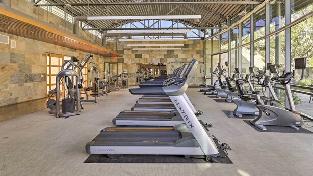 A gym with treadmills, stationary bikes, and weight machines. - Modern Irvine Condo w/ Pool - 7 Mi to Beach! (Irvine)