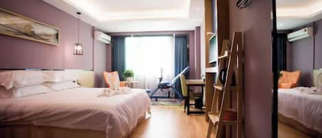 A hotel room with a bed, desk, chair, and a ladder.