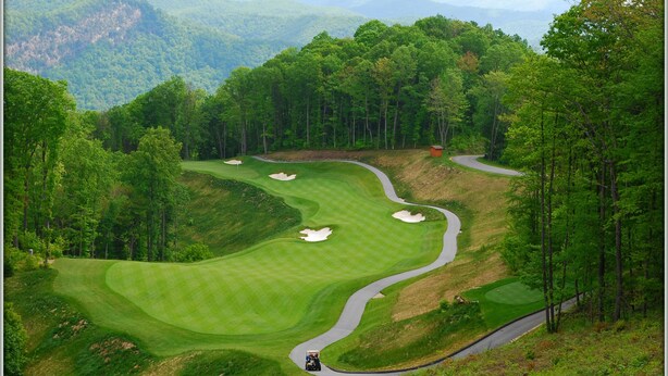 A golf course with a winding path, sand bunkers, and a clubhouse. - Hilltop Hideaway- Cozy Cabin w/ Fireplace, Private Deck/Yard, Family Friendly! (Cashiers)