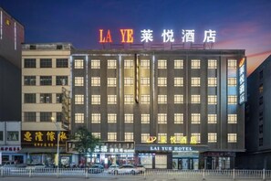 A multi-story hotel with a prominent sign at the top. - Laiyue Hotel (Huidong)
