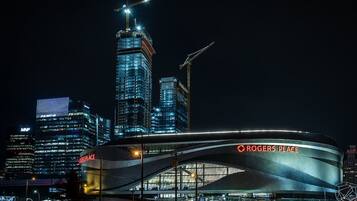 A modern stadium with a curved roof and the name "Rogers Place" on the facade.