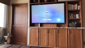 A television mounted on a wooden cabinet with a 'No Signal' message.