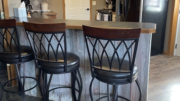 A kitchen with a bar area, wooden cabinets, a refrigerator, and a door. - Store that boat inside!  Blocks to boat ramps/Marina & Restaurant (Chamberlain)
