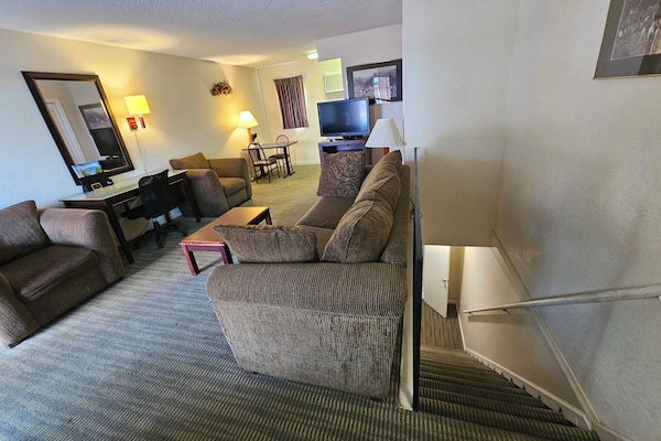 Signature Suite, Multiple Beds | Living area | 42-inch Smart TV with cable channels, TV