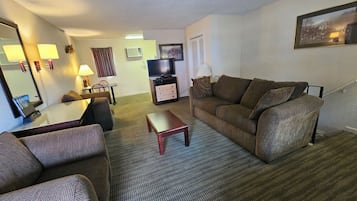 Signature Suite, Multiple Beds | Living area | 42-inch Smart TV with cable channels, TV