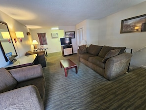 Signature Suite, Multiple Beds | Living area | 42-inch Smart TV with cable channels, TV