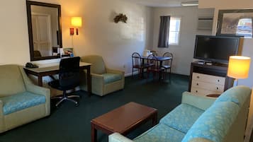 Signature Suite, Multiple Beds | Living area | 42-inch Smart TV with cable channels, TV