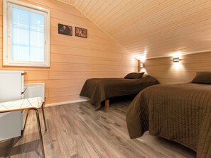 A room with two beds, a desk, and a window. - Villa nummenranta 1 by Interhome (Kuhmoinen)