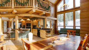 A spacious wooden cabin with a dining area, kitchen, and a balcony with Christmas decorations. - 9 Mi to Slopes! Hot Tub Hideaway in Breckenridge (Breckenridge)