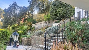 A stone staircase leading up to a building, surrounded by various plants and a lamp post. - Villa Schenk - Urb Rio de Oro, Calonge, Catalonia (Calonge)