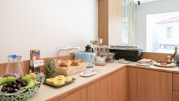 A breakfast buffet with various food items and beverages.