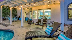 An outdoor patio with a pool, seating area, and string lights. - Terra Azul: Pool, Spa, Billiard Table, Foosball (Indio)