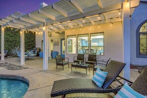 A covered outdoor patio with seating, a pool, and a view of the kitchen. - Terra Azul: Pool, Spa, Billiard Table, Foosball (Indio)