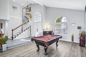 A spacious room with a pool table, a staircase, and a billiards rack. - Terra Azul: Pool, Spa, Billiard Table, Foosball (Indio)