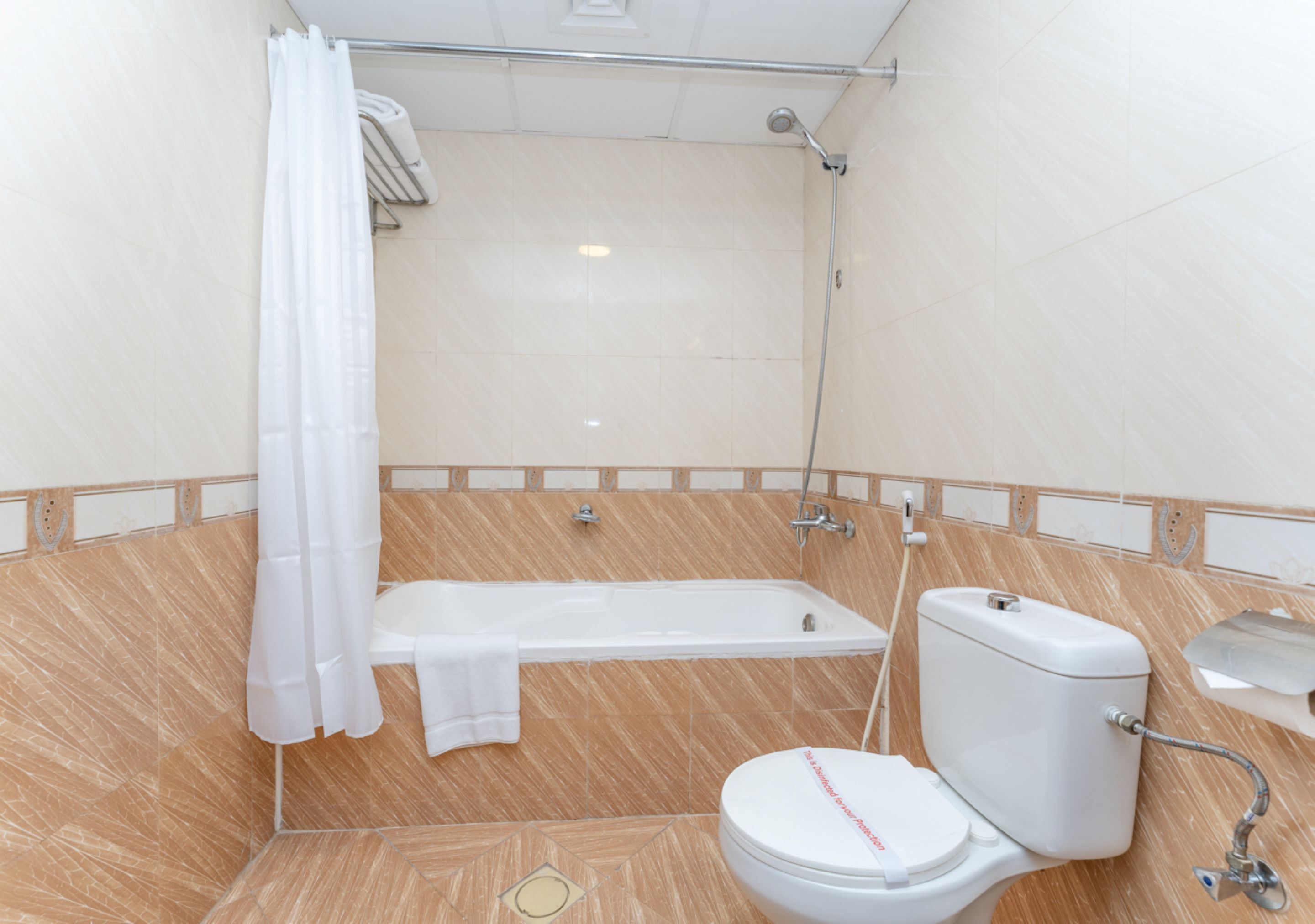 A bathroom with a bathtub, toilet, and shower.