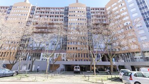 A multi-story building with a modern architectural design, featuring a mix of brick and glass facades. - Lisbon Flower 360º - Your Lovely Flat with Pool and Parking (Lisboa)