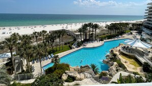A resort with a swimming pool, beach, and palm trees. - Gulf Front Condo with Stunning Views! (Pensacola)