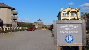 A sign indicating Martin Street Public Beach Access with a view of a beach entrance and a red car parked nearby. - Salty But Sweet at Sundune Village, Located 0.1 Miles from the Beach! (Kill Devil Hills)