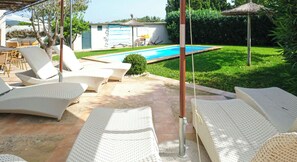 A poolside area with lounge chairs and umbrellas, a swimming pool, and a well-maintained garden. - Es Collet by Rentallorca (Manacor)