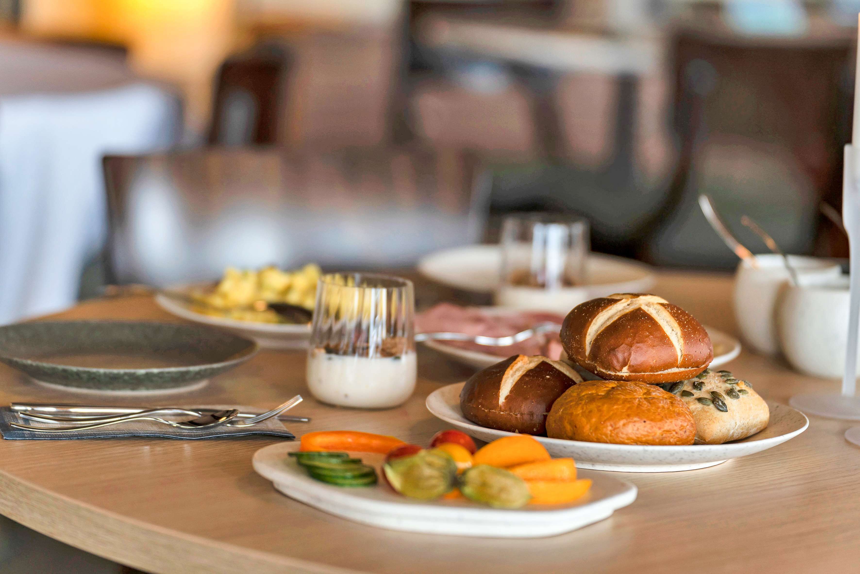 A breakfast setting with various pastries and fruits on a table.