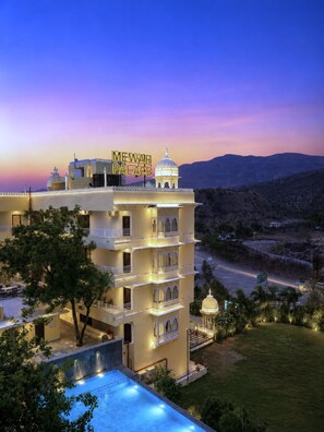 A multi-story hotel with a sign reading 'MEWAR PALACE' and a pool area. - Mewar Palace Luxury Resort & Private Pool Villas - Udaipur (Udaipur)