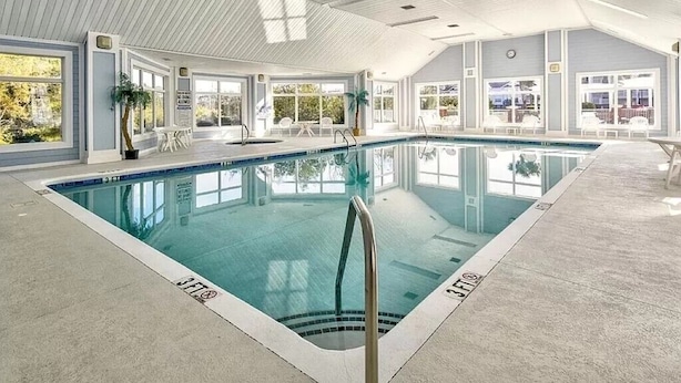 An indoor swimming pool with clear markings, a tiled floor, and a ceiling with skylights. - Villa #706: 4  BR, 3  BA Condominium in Garden City, Sleeps 8 (Garden City)
