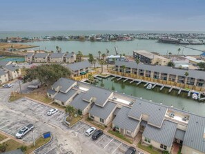 A coastal hotel with multiple buildings, a marina, and a parking lot.