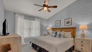 A bedroom with a bed, bedside lamps, a ceiling fan, a TV, and a desk. - A Fishers ParadiseW/Boatdock! (Rockport)