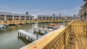 A waterfront hotel with multiple buildings, docks, and fishing rods. - A Fishers ParadiseW/Boatdock! (Rockport)