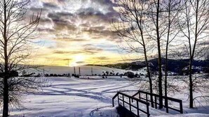 A snow-covered landscape with a wooden bridge and bare trees. - Entire Studio Apartment - close to town BRAND NEW AC (Missoula)