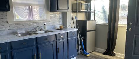 Fridge, microwave, cookware/dishes/utensils, dining tables