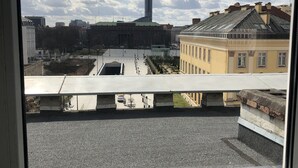 A view from a window of a building with a clear sky, a modern skyscraper, and traditional architecture. - KW38 - 2 min to Old Market Square and Townhall (Wroclaw)