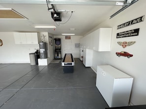 Enjoy meals and entertainment in this compact space with a central table, cabinets, and a small refrigerator.