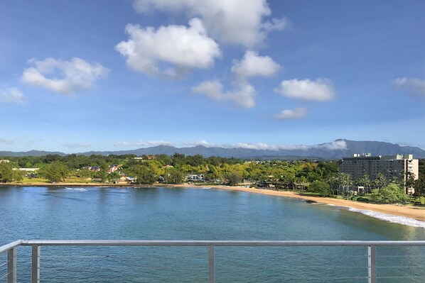 A coastal view with a clear sky, a beach, and mountains in the background. - Stunning Oceanfront Home @ Kalapaki Bay, AC, Sleeps 8 (Lihue)
