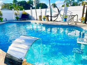 Outdoor pool, a heated pool - Work & Family Retreat: 4BR w/ Heated Pool, Fast Wi-Fi, Near Airport, Hard Rock (Fort Lauderdale)