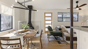 A modern kitchen with a dining table, chairs, and a built-in stove. - Designer Bungalow in Heart of Sedona, Enclosed Yard/Patio, Luxe Kitchen (Sedona)