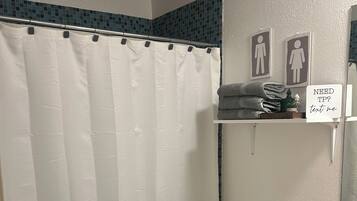 Bathtub, towels, soap, shampoo