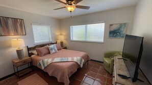 A bedroom with a bed, a ceiling fan, a TV, and a window with blinds. - Rock Ridge lll.  Close to everything. (Vero Beach)