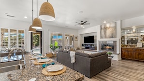 A modern kitchen with granite countertops, a built-in oven, and a large island with seating.