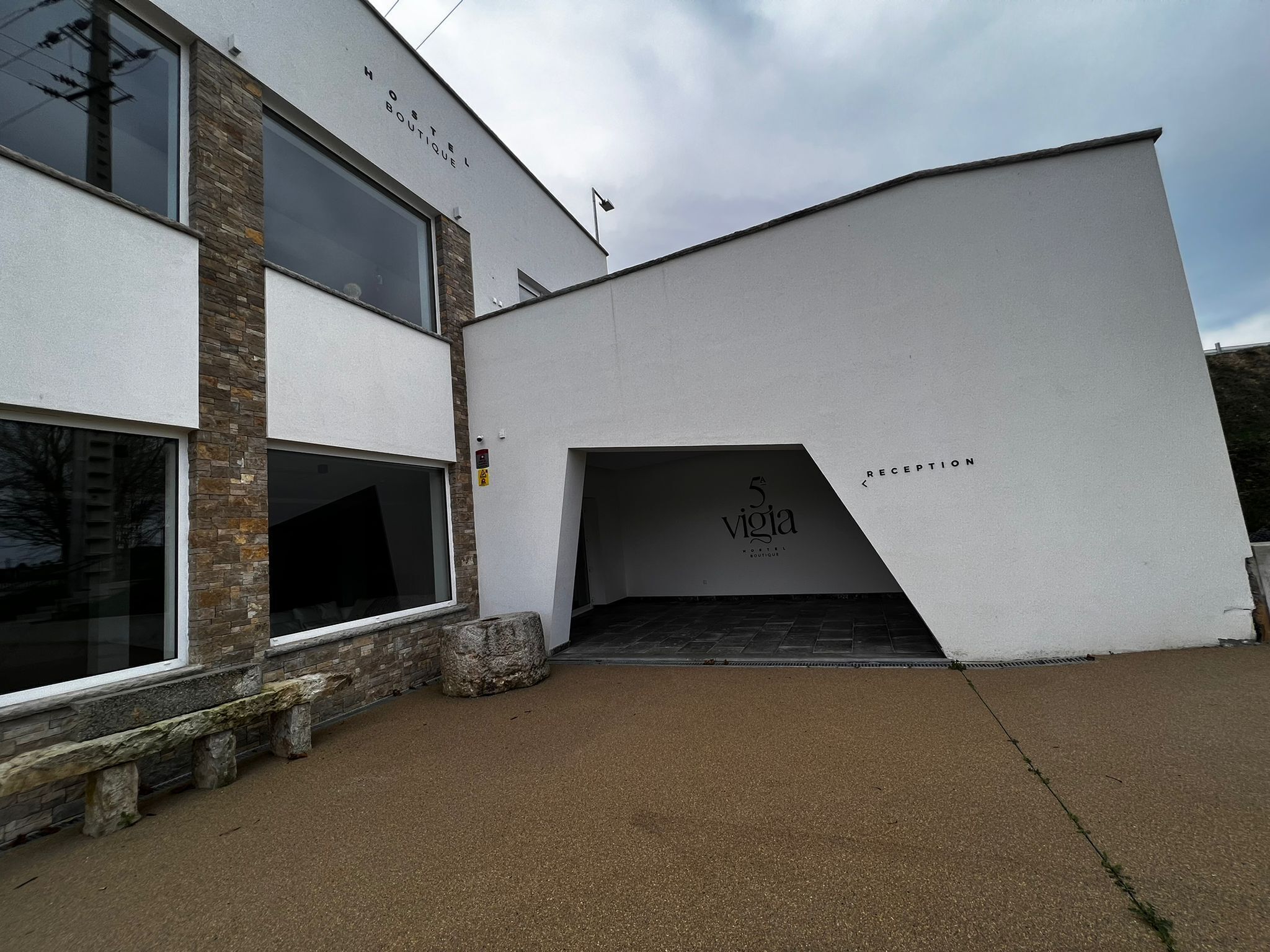 A modern building with a stone facade and large windows.